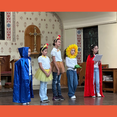 Small children perform music on stage