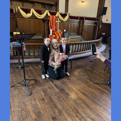 Woman and two boys posing in church