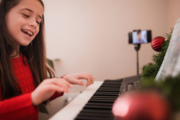 Smiling girl playing a digital piano