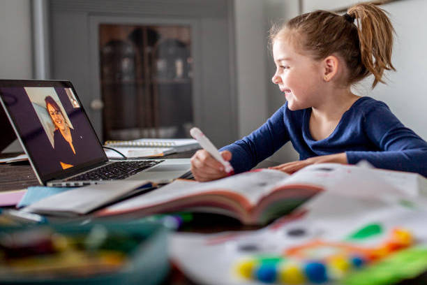 Young girl having an online lesson on a laptop