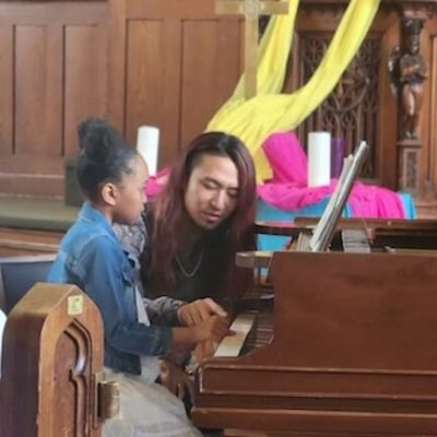 Young girl having a piano lesson