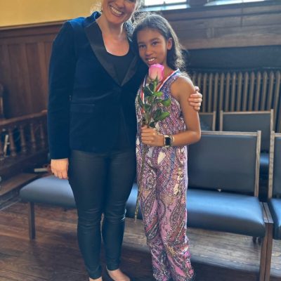 Woman and young girl holding a rose