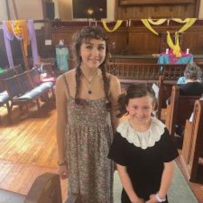 Woman and young girl standing in church