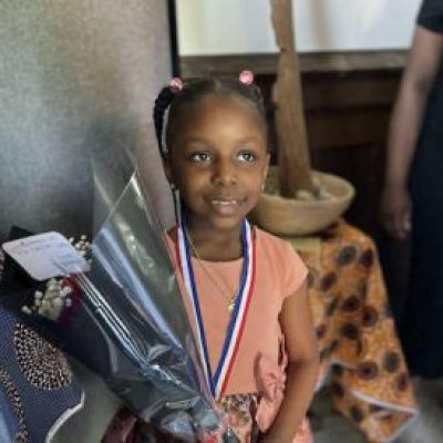 Girl with medal and flowers